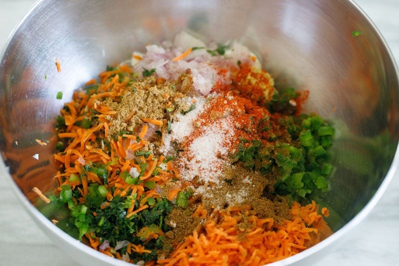 Colorful mixture of vegetables and spices in a bowl.