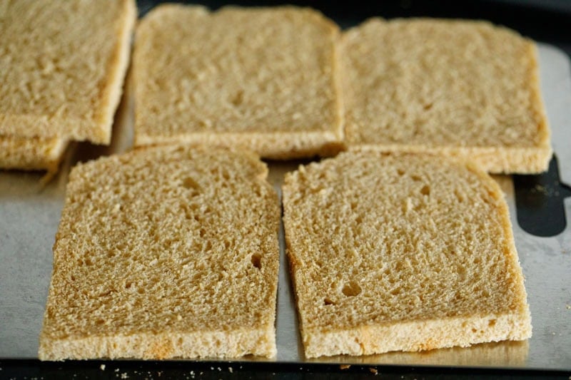 Slices of brown bread with their edges sliced off arranged neatly.