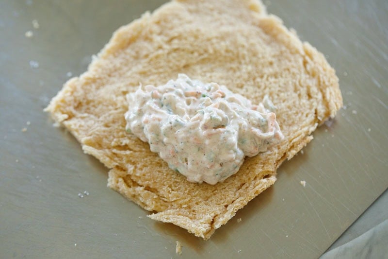 Flatbread with creamy filling on corner side of flattened bread.