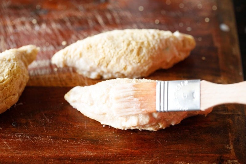 Brushing rolls with sealing flour paste.
