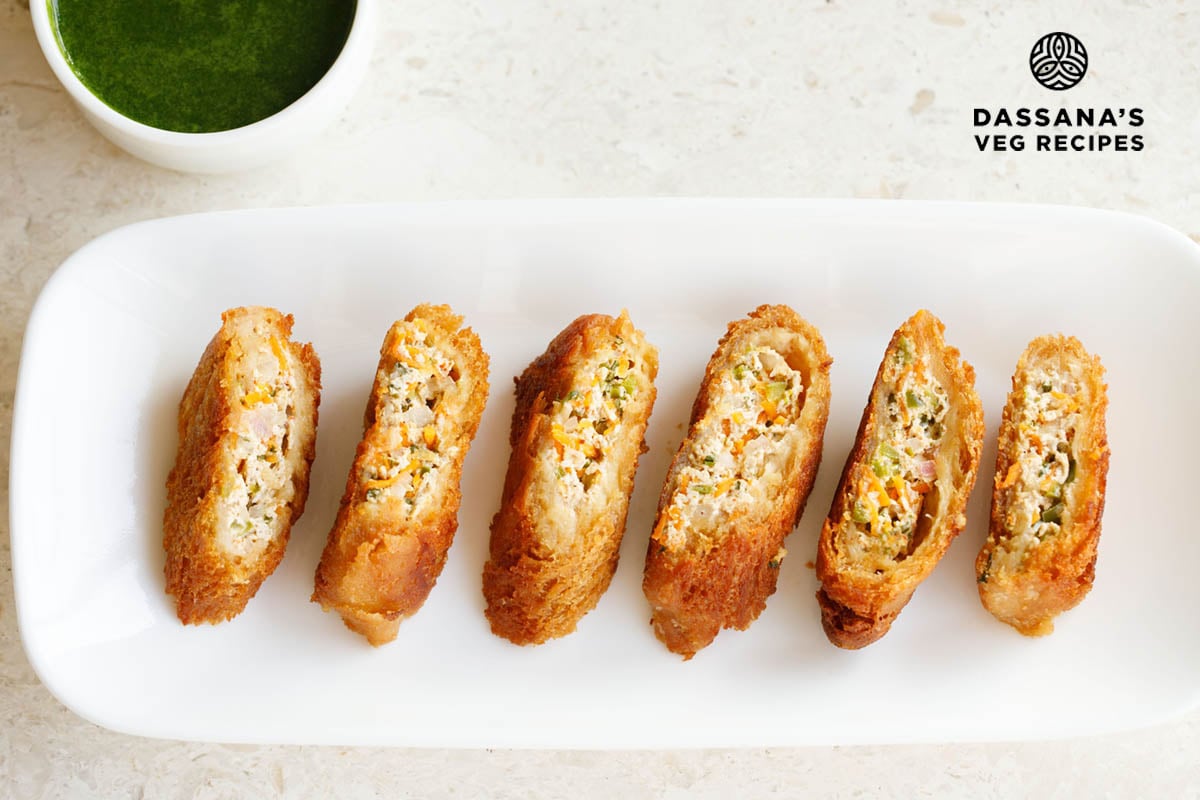 Crispy stuffed dahi ke sholey slices on a white plate.