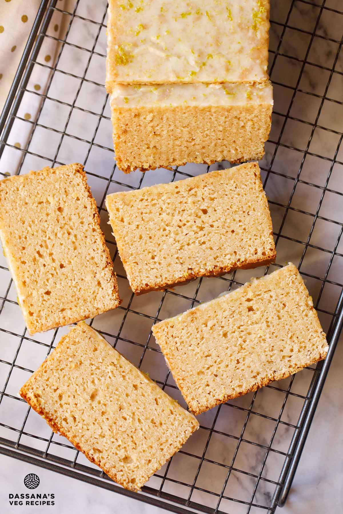 Sliced lemon pound cake on rack.