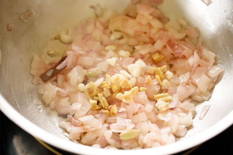 Chopped ginger and garlic with onions in skillet.