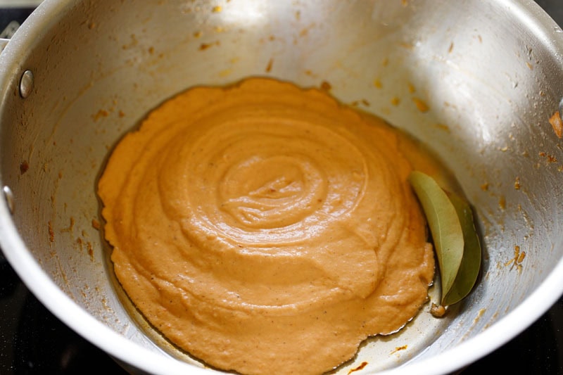 Ground masala paste in pan with tej patta and oil.