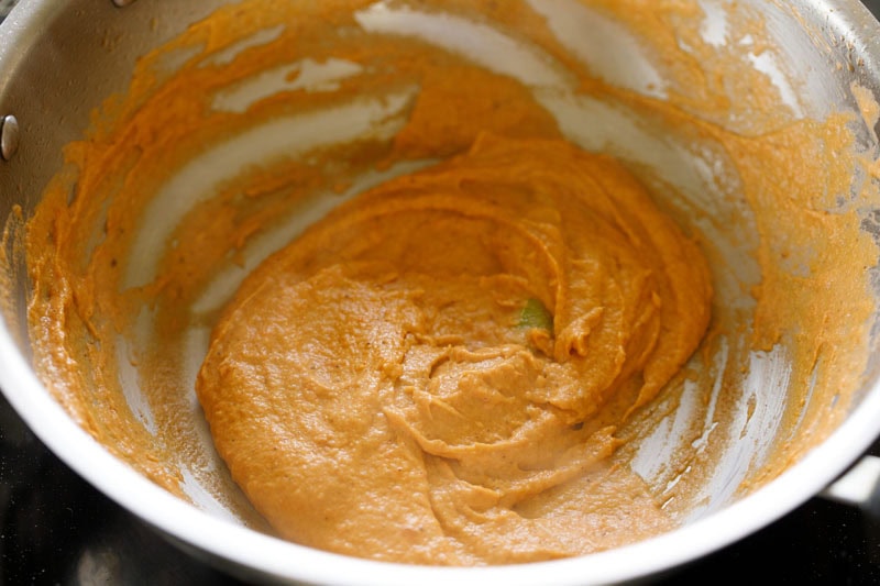 Ground masala paste being sautéed in pan.