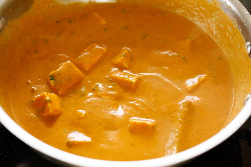 Paneer cubes and coriander mixed with the gravy.