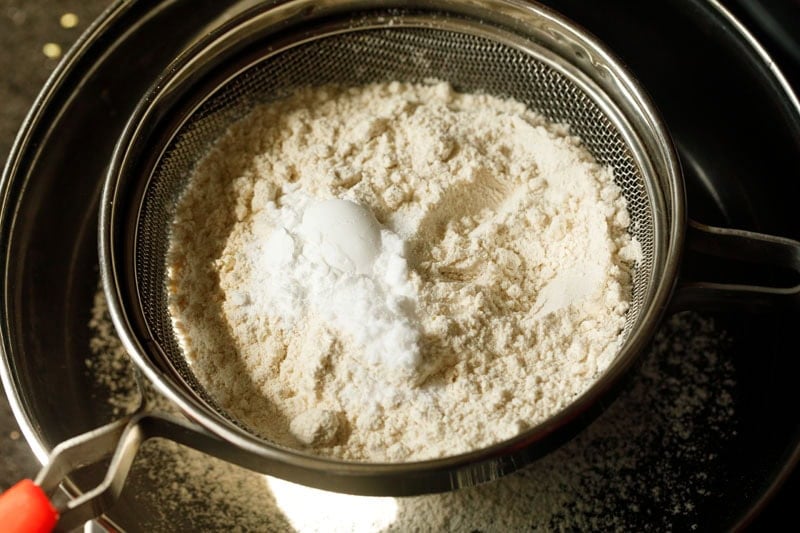 Sifting whole wheat flour, salt, baking soda and baking powder mixture