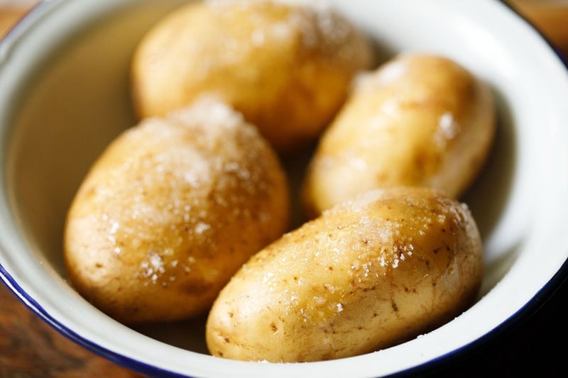 Oil drizzled on potatoes.