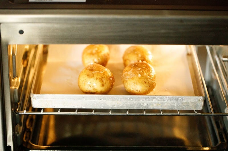 Potatoes being baked in oven.