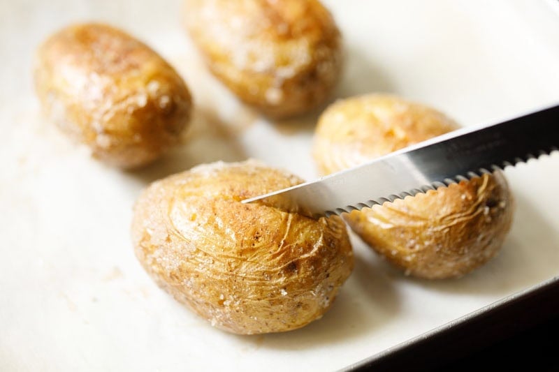 Slicing a baked potato.