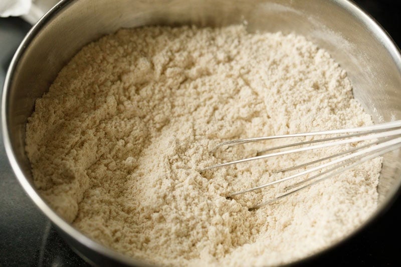 Bowl of flour with whisk.