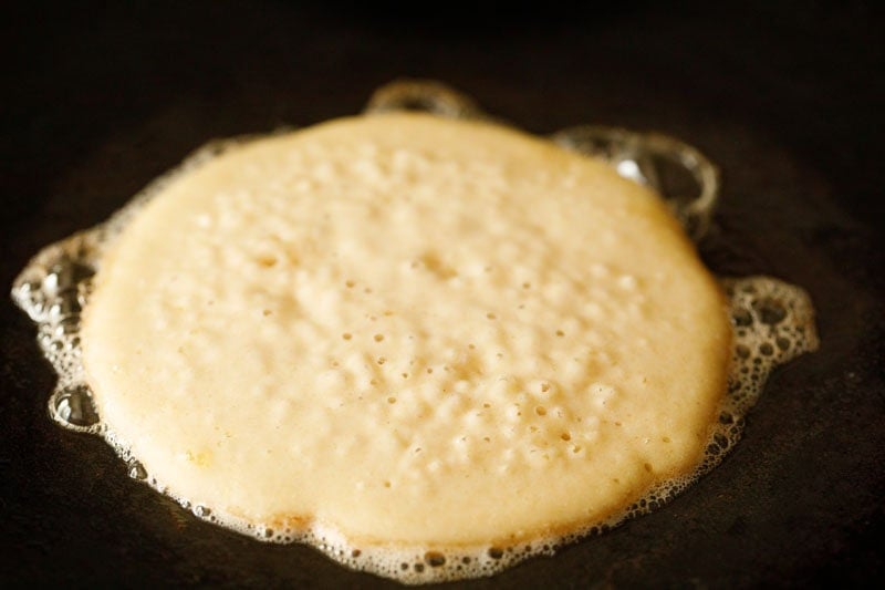 Buttermilk pancake cooking on a skillet.