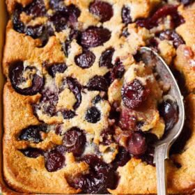 Baked cherry cobbler with spoon.