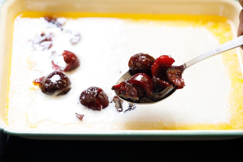 Spoonful of cherries over batter.