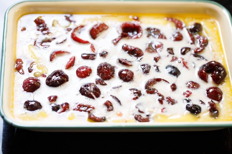 Baking dish with cherry cobbler mixture.