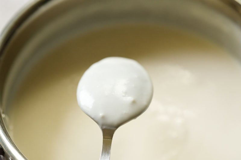 Thickened cream custard coating back of spoon.