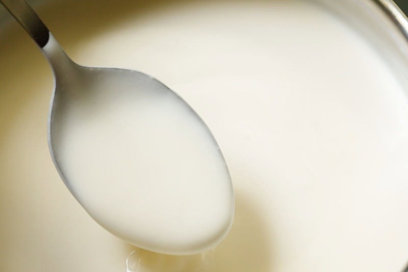 Consistency of creme brûlée custard being shown with a spoon.