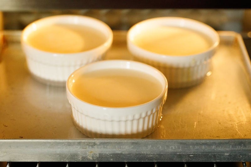 Baking creme brulee custard in oven.