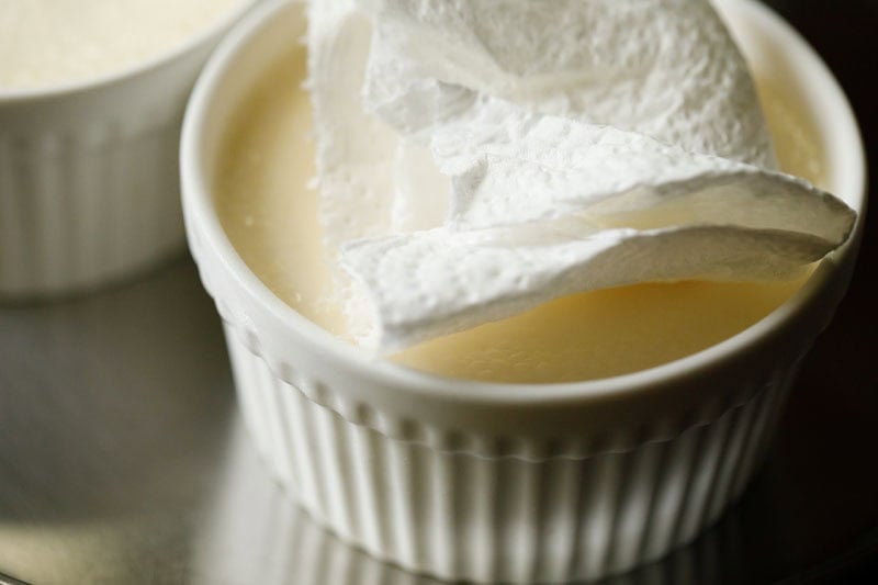 Paper towel being used to absorb the condensation droplets from the surface.