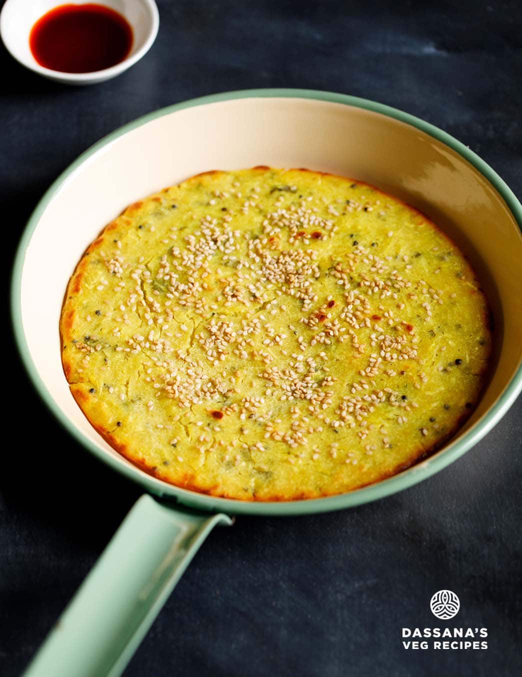 Golden brown savory handvo cake with sesame