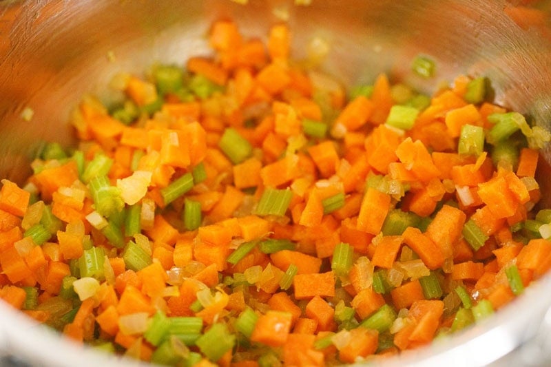 Chopped carrots and celery in pot.