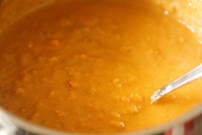 Thick lentil soup in pot.