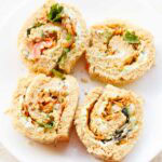 Pinwheel sandwich on white plate.