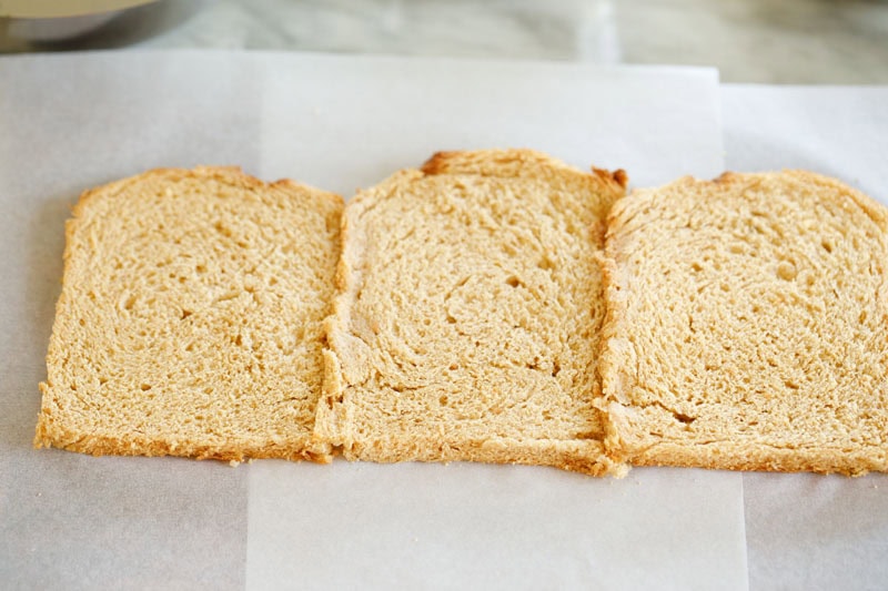 Three bread slices placed closely and joined by brushing with water on the edges.