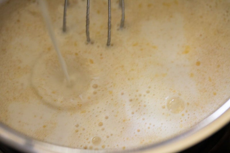Whisking creamy mixture in pot