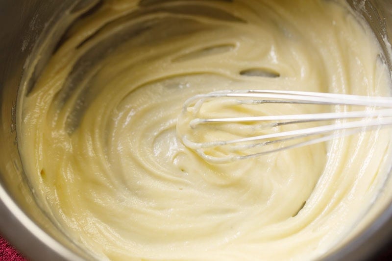 beating ghee with a wired whisk till smooth for making badusha.