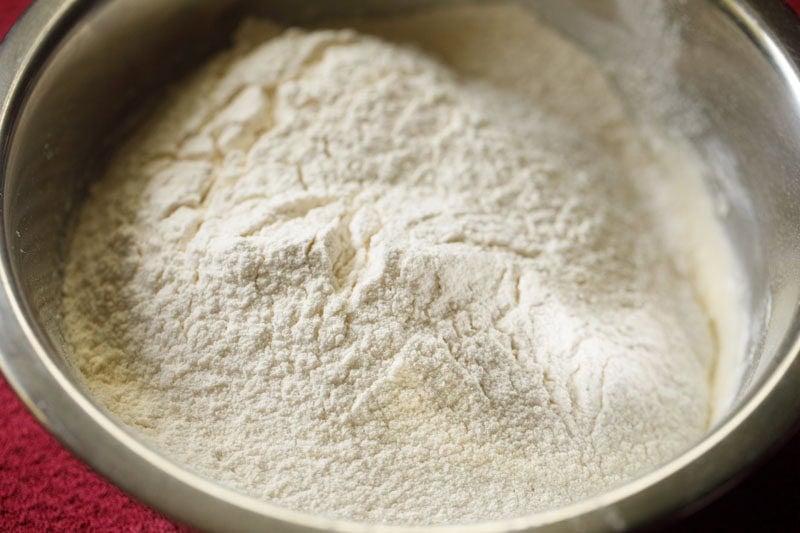 flour sifted directly into the creamed mixture for making balushahi.