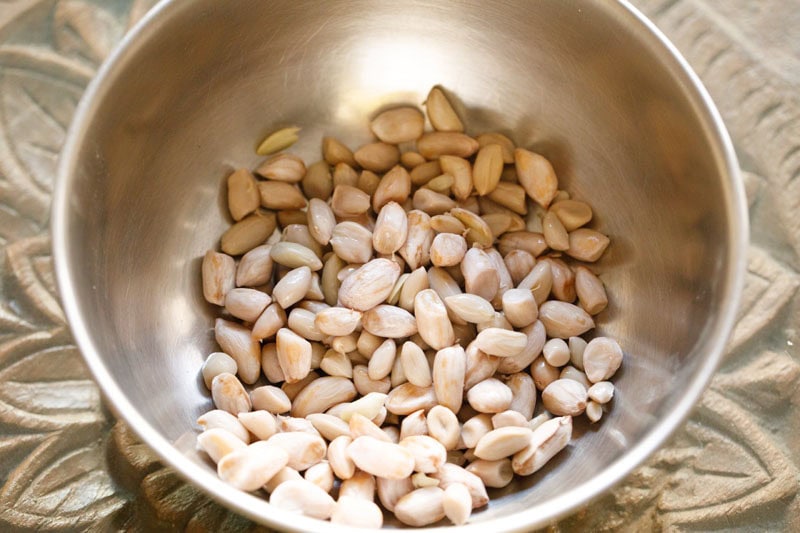 Bowl of raw, shelled peanuts.