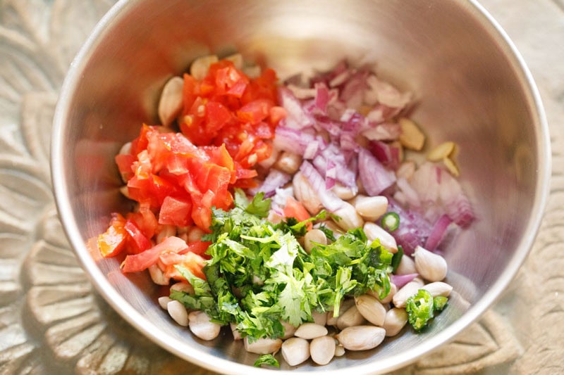Bowl of chopped vegetables and peanuts.