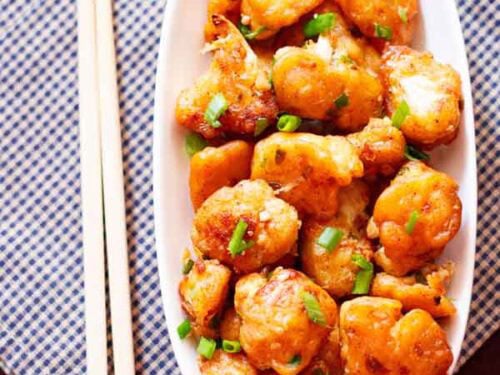 Gobi manchurian garnished with green onions.