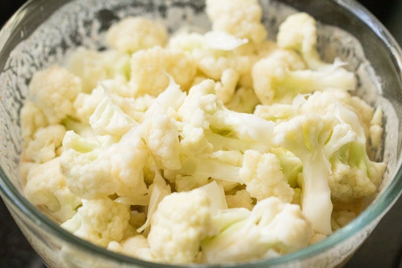 Bowl of chopped cauliflower florets with batter.