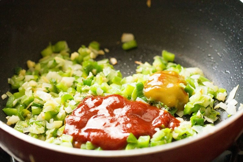Chopped vegetables with sauces in pan.