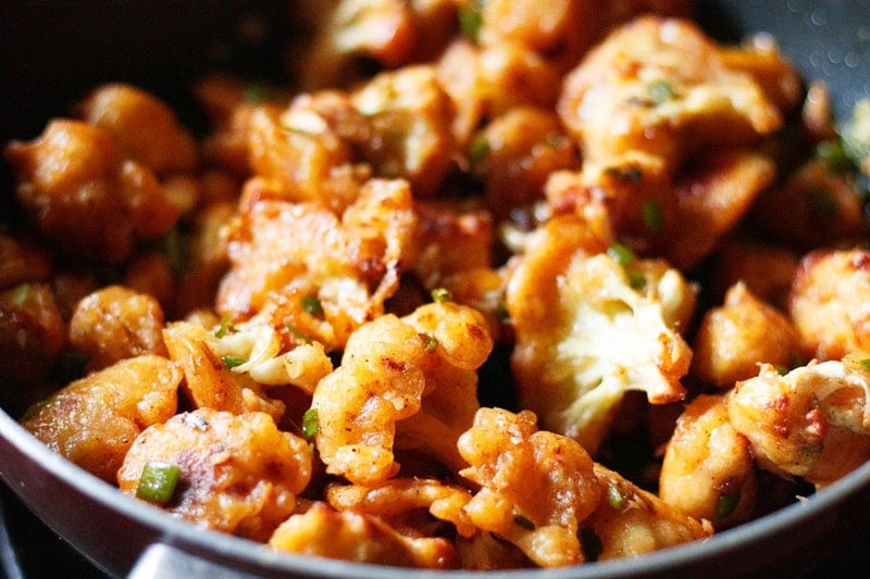 Fried cauliflower coated with spicy manchurian sauce.