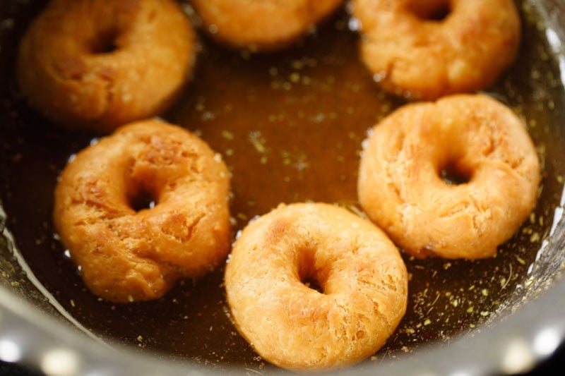fried balushahi in warm sugar syrup.