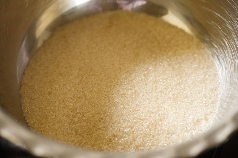 sugar added to a pan for making sugar syrup for badusha sweet.