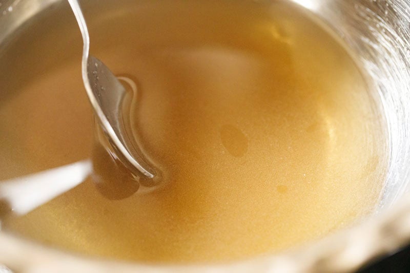 stirring sugar solution for balushahi sweet.