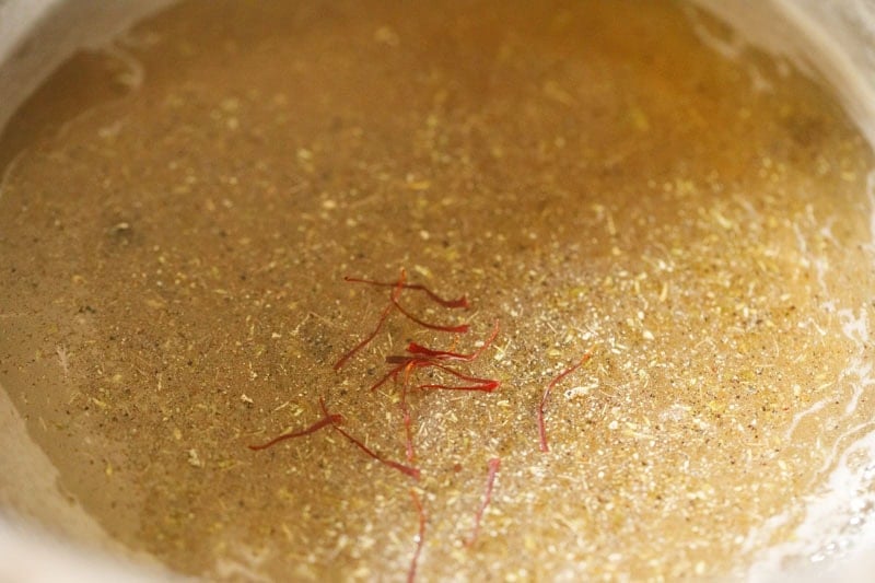 cardamom powder and saffron strands added to the sugar syrup.