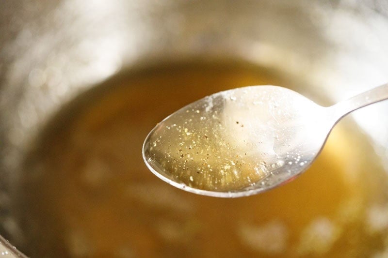 sticky sugar syrup in a spoon for testing.