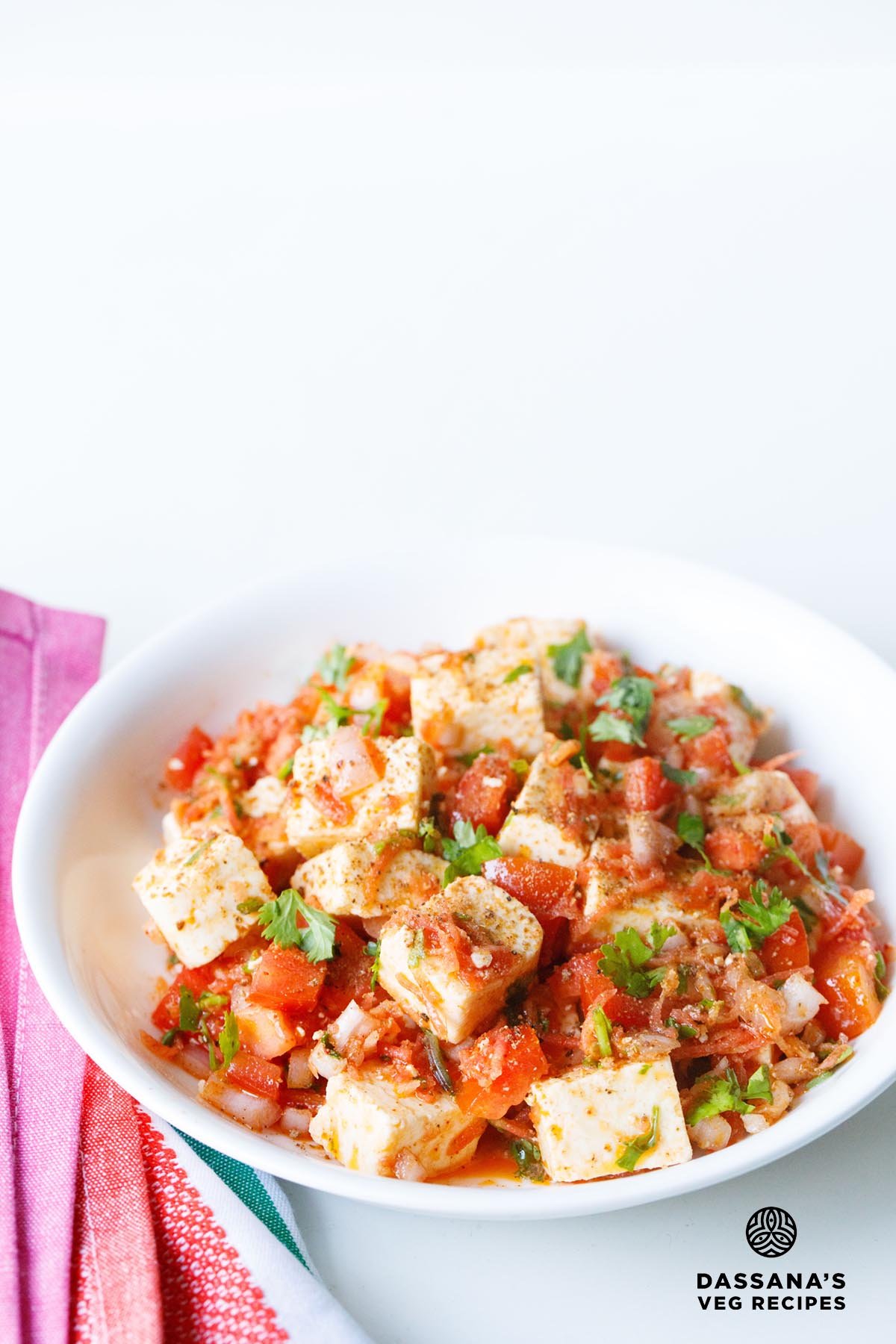Colorful paneer salad in a white bowl.