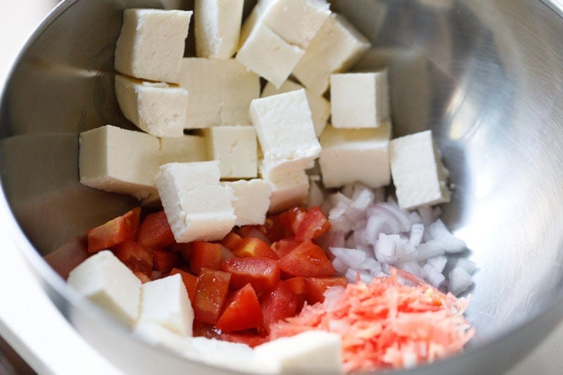 Cubed paneer with chopped vegetables.