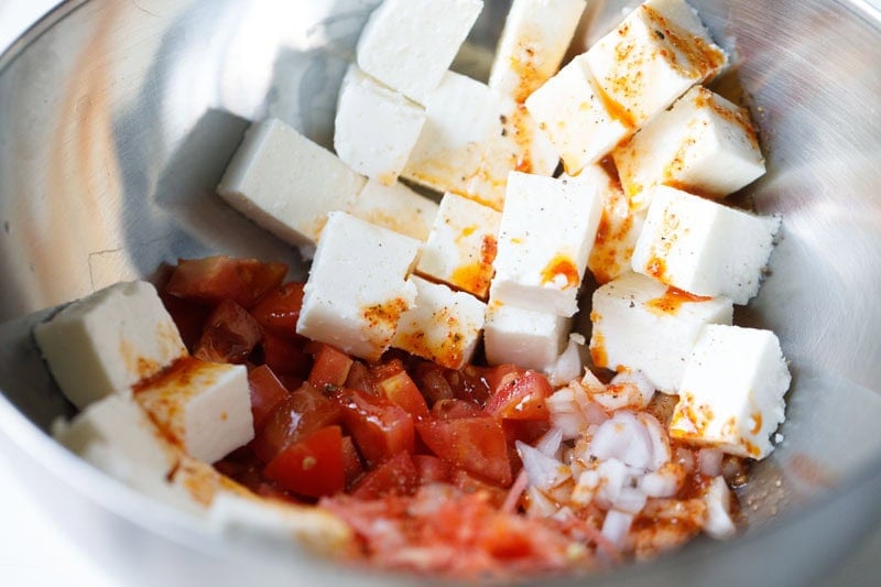 Cubed paneer with tomatoes, onions and dressing.