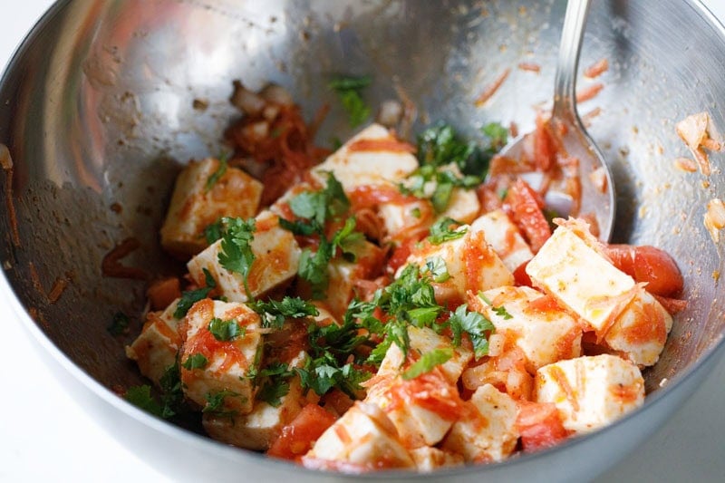 Paneer salad with tomatoes and herbs.