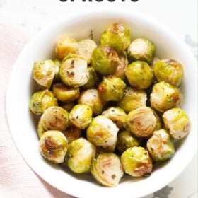 Bowl of roasted Brussels sprouts with text layovers.