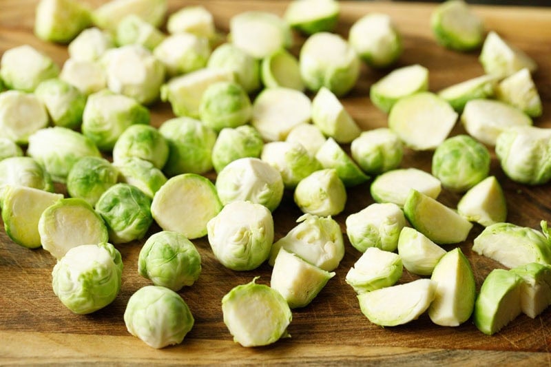 Chopped Brussels sprouts on wooden board.