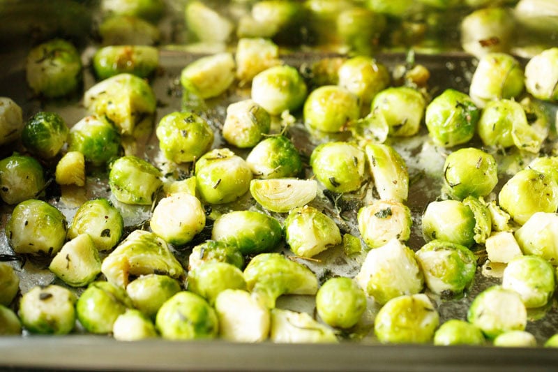 Half-roasted brussels sprouts on baking tray.