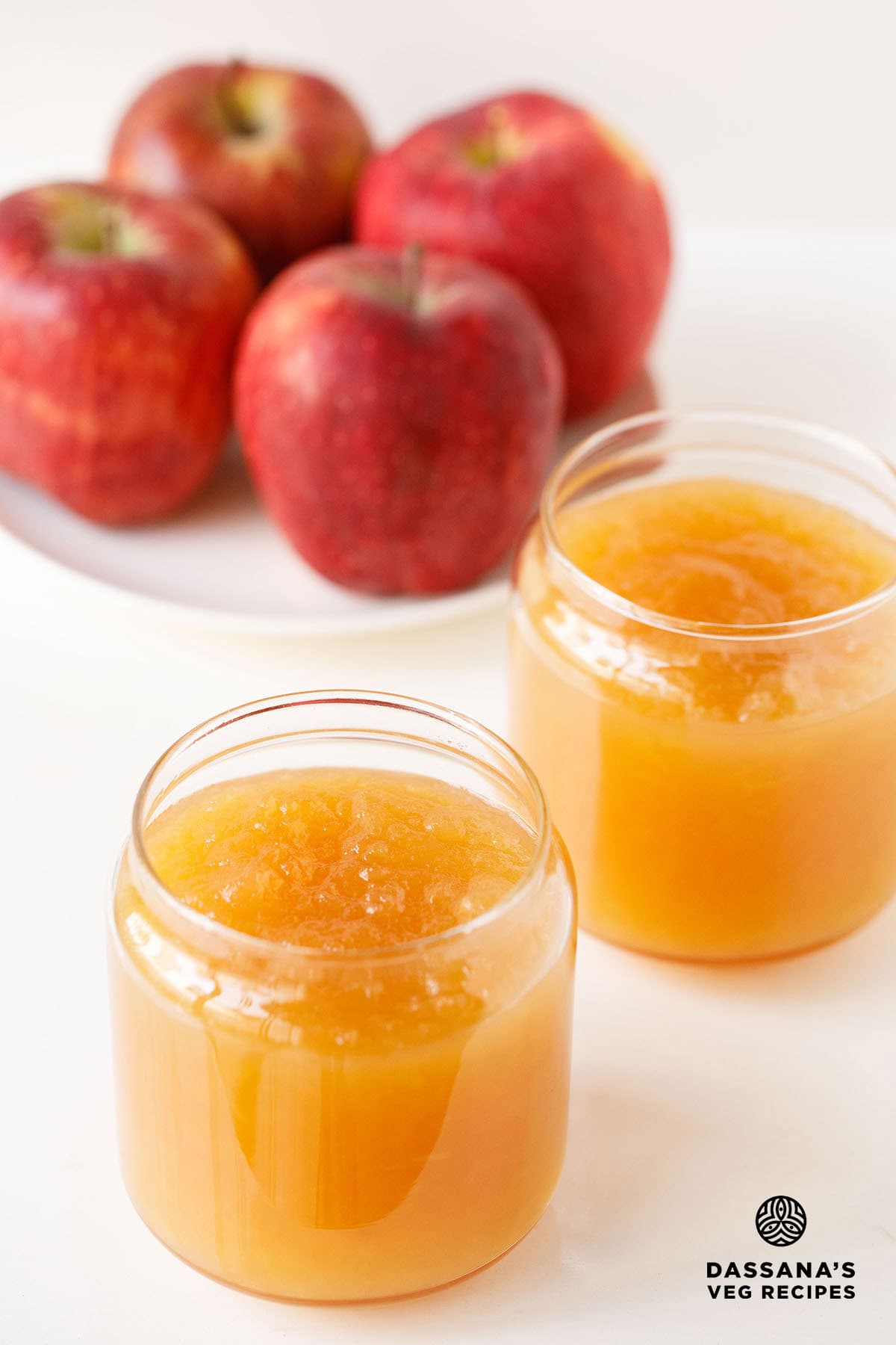Apple jam in two glass jars.